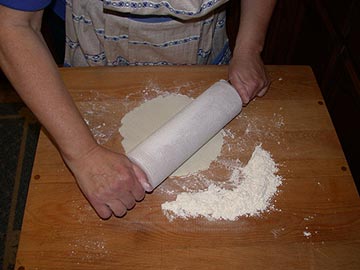 Rolling the lefse from the center out to the edges