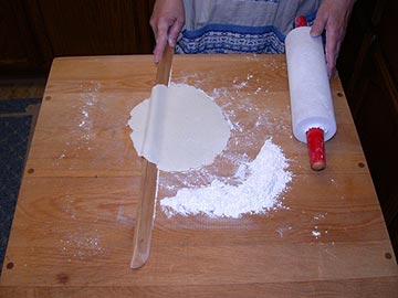 Turning the lefse with the one-edged lefse stick