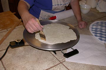 Brushing the crumbs off the griddle