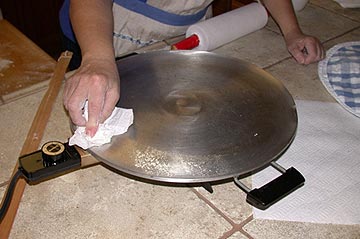 Wiping the crumbs off the lefse griddle