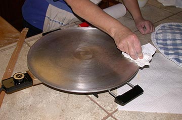 Wiping the crumbs off the lefse griddle